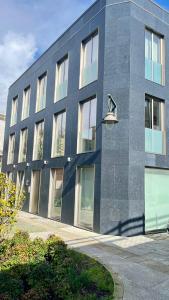 a building with a street light in front of it at D'AUSE - New Modern Apt - 150m to Beach & Center in Esposende