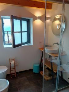 a bathroom with two sinks and a glass shower at Chalet Nest in Gravedona