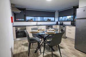 a kitchen with a table and chairs in a kitchen at Casa da Eira Campia in Vouzela