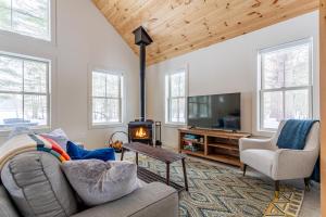 a living room with a couch and a fireplace at Lakefront with Private Dock & Canoe Kenoza Den in Jeffersonville