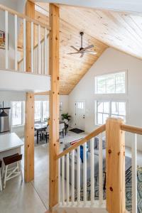 a room with a loft with a staircase and a dining room at Lakefront with Private Dock & Canoe Kenoza Den in Jeffersonville