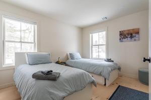a bedroom with two beds and two windows at Lakefront with Private Dock & Canoe Kenoza Den in Jeffersonville