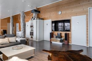 a living room with a couch and a table at Villa West Ellivuori - High Quality 6BR Villa with Jacuzzi in Sastamala +33 photos