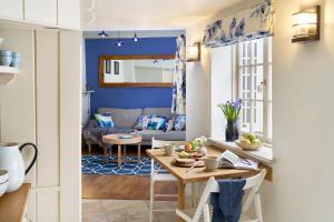 a living room with a table and a couch at Courtyard Cottages Lymington, 2 Adults only in Lymington +19 photos