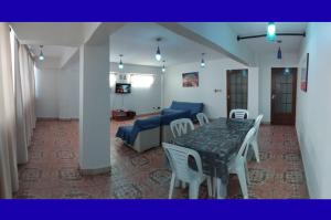 a living room with a table and chairs and a couch at Space in Cochabamba
