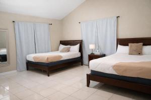 a bedroom with two beds and a mirror at Stellarium Hotel-Valle de Guadalupe in Francisco Zarco +81 photos