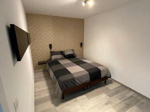 a bedroom with a bed and a television in it at Residence pascalino in Ans