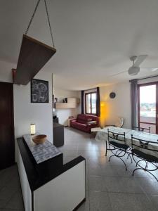 a living room with a couch and a table at Easy Albese Comfort in Albese Con Cassano