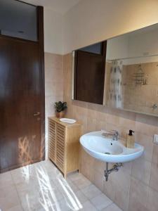 a bathroom with a sink and a mirror at Easy Albese Comfort in Albese Con Cassano +45 photos