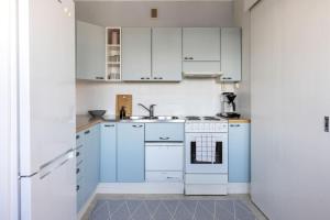 a white kitchen with white cabinets and a sink at Borg Isolinna, Spacious 2-Room Apt For 4, Free Parking in Pori +23 photos