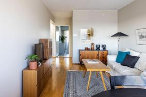 a living room with a couch and a table at Borg Isolinna, Spacious 2-Room Apt For 4, Free Parking in Pori