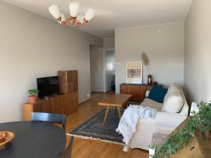 a living room with a couch and a table at Borg Isolinna, Spacious 2-Room Apt For 4, Free Parking in Pori