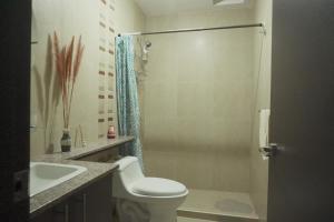 a bathroom with a toilet and a sink and a shower at Casa Calma in Quito +35 photos
