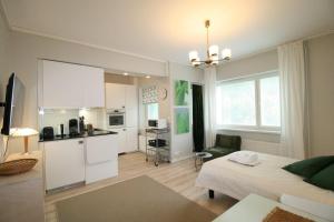 a room with a kitchen and a living room at Borg Kiertokatu, Spacious Studio Apt, Free Parking in Pori