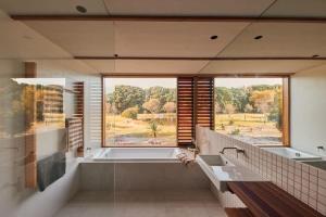 a bathroom with a tub and a large window at Ellas Rest in Torquay
