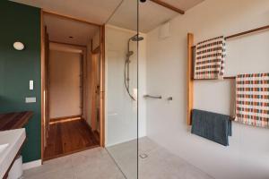 a bathroom with a shower with a glass door at Ellas Rest in Torquay +31 photos