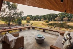 a large screened in porch with a view of a lake at Ellas Rest in Torquay