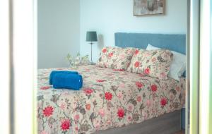 a bed with a blue suitcase sitting on top of it at Chalet Molly92 in Antigua +70 photos