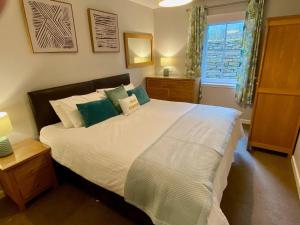 a bedroom with a large bed and a window at Kirkwall town centre apartment 1 in Kirkwall