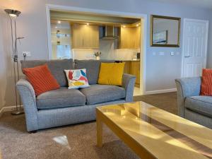 a living room with a couch and a table at Kirkwall town centre apartment 1 in Kirkwall +49 photos