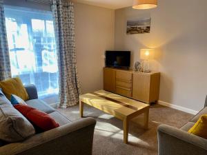 a living room with a couch and a coffee table at Kirkwall town centre apartment 1 in Kirkwall