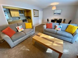 a living room with two couches and a coffee table at Kirkwall town centre apartment 1 in Kirkwall