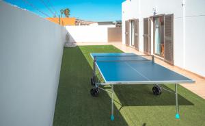 a blue ping pong table on a lawn at Chalet Molly92 in Antigua
