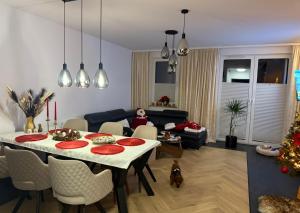 a living room with a table and a christmas tree at S Golf Apartament in Gowinko