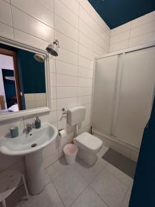 a bathroom with a sink and a toilet and a shower at Palazzo montagna in Grotte +29 photos