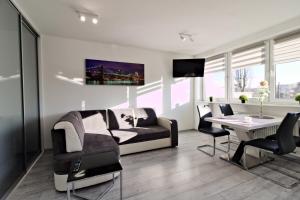 a living room with a couch and a table at LC pokoje & apartamenty B52 in Szczecin