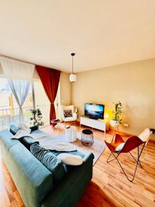 a living room with a couch and a television at Sea View apartment in Sliema in Sliema
