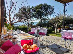 a table with bread and pastries on it at L'Alcova tra gli ulivi in Zoagli