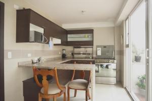 a kitchen with two chairs and a counter top at Casa Calma in Quito