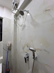 a bathroom with a shower and a sink at Sumeru in Mumbai