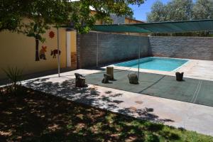 a swimming pool in the backyard of a house at Kenhardt Hotel in Kenhardt