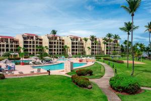 a resort with a swimming pool and palm trees at Crescent Beach by Otium in Humacao
