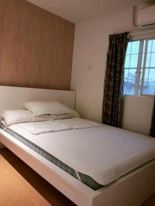 a bedroom with a large bed with a window at Modern 2 Storey 2BR Home with 2 Parking Space in Manila