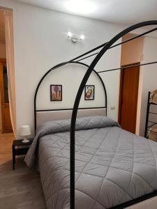a bedroom with a bed with a black canopy at Palazzo montagna in Grotte