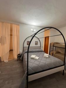 a bedroom with a bed with an iron frame at Palazzo montagna in Grotte