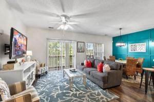 a living room with a couch and a table at Charming 3-Bedroom Cherry Grove Condo in Myrtle Beach