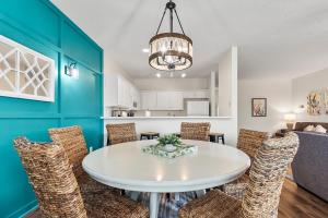 a dining room with a white table and chairs at Charming 3-Bedroom Cherry Grove Condo in Myrtle Beach