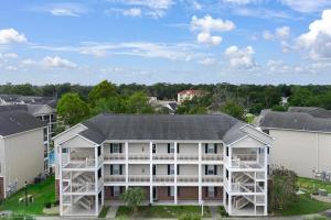 an aerial view of a white apartment building at Charming 3-Bedroom Cherry Grove Condo in Myrtle Beach