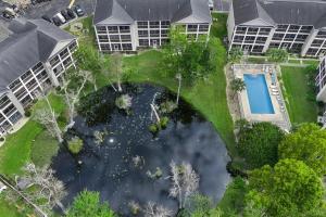 an aerial view of a pool in a yard with buildings at Charming 3-Bedroom Cherry Grove Condo in Myrtle Beach