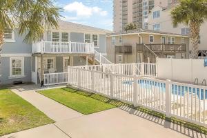 a house with a white fence and a pool at Crescent Beach 3 Bedroom with Pool, Across the Street from Ocean in Myrtle Beach