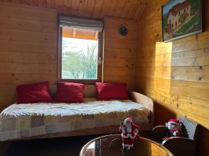 a small room with a bed in a log cabin at Gîte des Buis de l'Ain in Groslée +43 photos
