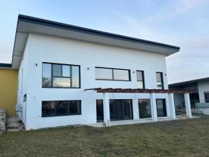 a white house with black windows at Haus am Akazienweg in Steinberg an der Rabnitz