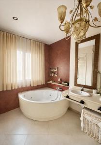 a large bathroom with a large tub and a sink at Sonia Home in Córdoba +13 photos