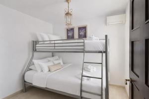 a bedroom with a bunk bed with white pillows at Sonia Home in Córdoba