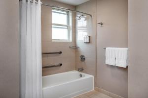 a white bathroom with a tub and a window at Hotel Adagio, Autograph Collection in San Francisco +59 photos