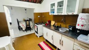 a kitchen with a sink and a stove at Residência Central Triunfo-PE in Triunfo
